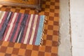 Handmade carpet on tiled checkered floor, carpet on the floor Royalty Free Stock Photo