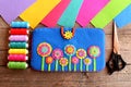 Handmade case for tablet. Felt blue case with bright flowers, thread kit, felt sheets, scissors on old wooden background Royalty Free Stock Photo