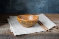 Handmade ceramic bowl on a wooden background, wabi sabi style Royalty Free Stock Photo