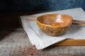 Handmade ceramic bowl on a wooden background, wabi sabi style Royalty Free Stock Photo