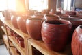 Handmade ceramic clay terracotta jugs, pots, vases, souvenirs on shelves in street craft pottery shop. Clay brown ceramic pot jug. Royalty Free Stock Photo