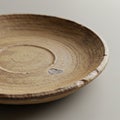 A handmade ceramic plate with a rustic, earthy appearance. The plate is round with a Royalty Free Stock Photo