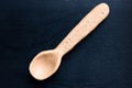 Handmade ceramic spoon on black wooden background