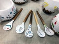 Handmade ceramic spoons with wooden handle on linen. Home and Kitchen Decor, Pottery Gift. Antique vintage multicolored tableware