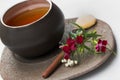 Handmade ceramic tea cup with burgundy flowers