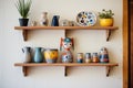 handmade ceramics displayed on a wooden shelf