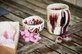 Handmade ceramics. Ice cubes, frozen berries, on wooden background.Freshness, rustic