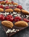 Handmade chocolate bar filled with almonds, cherries and sesame seeds.