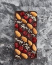 Handmade chocolate bar filled with almonds, cherries and sesame seeds.