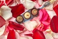 Handmade chocolates on vintage silver spoon amidst rose petals