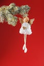 Handmade christmas angel toy on a Christmas tree on a red background Royalty Free Stock Photo