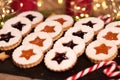 Handmade Christmas cookies against a backdrop of glowing lights. Linzer Cookies. Holiday baking and decor for Christmas and New Ye
