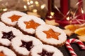 Handmade Christmas cookies against a backdrop of glowing lights. Linzer Cookies. Holiday baking and decor for Christmas and New Ye