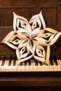 Handmade Christmas paper Star on piano