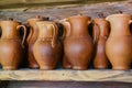 Handmade clay jugs on shelf in shop, closeup