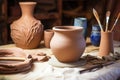 handmade clay pottery with tools on a wooden table Royalty Free Stock Photo