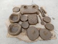 Handmade clay toys for kids to play. Indian small toy kitchen vessels made of soil on the floor. child makes dishes and various Royalty Free Stock Photo