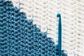 Handmade close-up simple blue and white crochet pattern with crochet hook Royalty Free Stock Photo