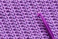 Handmade close-up simple lilac crochet pattern with crochet hook Royalty Free Stock Photo