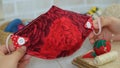 Handmade cloth mask with white buttons in red rose fabric pattern