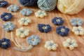 Handmade colorful crochet flower with skein on wooden table Royalty Free Stock Photo