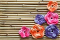 Handmade colorful crochet flowers on bamboo