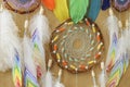 Closeup colorful dreamcatcher details on striped craft wrapping paper background