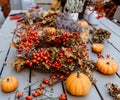 Handmade colorful floral autumn door wreath made of colorful rosehip berries, rowan, dry flowers and oak leaves