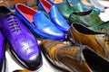 Handmade colorful luxury man shoes in a factory.