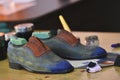 Handmade colorful luxury man shoes are hand-painted in a production factory.