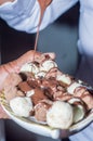 handmade condensed milk and chocolate popcorn in a bowl with chocolate syrup falling on top