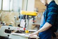 Carpenter engaged in processing wood at the sawmill. Royalty Free Stock Photo