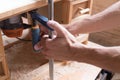 Handmade and craft furniture concept Carpenter engaged in processing wood in his workshop. Man hands working in furniture wood Royalty Free Stock Photo