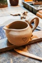 Handmade creamer. A small earthenware jug. A clay jug on Royalty Free Stock Photo