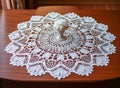 Handmade crochet white lace napkin on table in living room