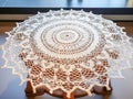 handmade crochet white lace tablecloth on glass table