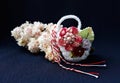 Handmade crocheted basket with spring flowers and red and white string, known as Martisor. Royalty Free Stock Photo