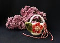 Handmade crocheted basket with spring flowers and red and white string, known as Martisor. Royalty Free Stock Photo