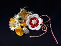 Handmade crocheted flower with red and white string, known as Martisor.