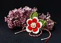 Handmade crocheted flower with red and white string, known as Martisor.