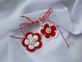 Handmade crocheted flowers with red and white string, known as Martisor. Royalty Free Stock Photo