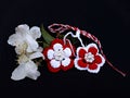 Handmade crocheted flowers with red and white string, known as Martisor. Royalty Free Stock Photo