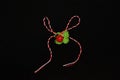 Handmade crocheted four-leaf clover with ladybug and red and white string, known as Martisor.