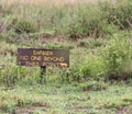 A handmade danger sign from a safari lodge in the savanna grassland of Africa.