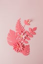 Handmade decorative paper pattern from tropical monochrome flower leaves on a pastel pink background with copy space. Top view.