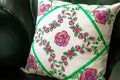 Handmade decorative pillow with rose embroidery.