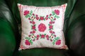 Handmade decorative pillow with rose embroidery.