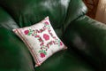 Handmade decorative pillow with rose embroidery.