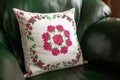 Handmade decorative pillow with rose embroidery.