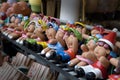 Handmade dolls for Garden decorations are lined up on shelves.